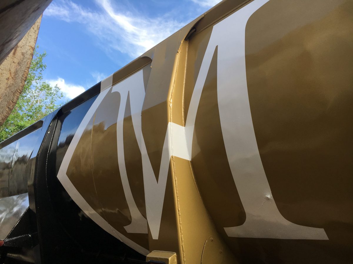Large coated industrial equipment with M in gold and white finish