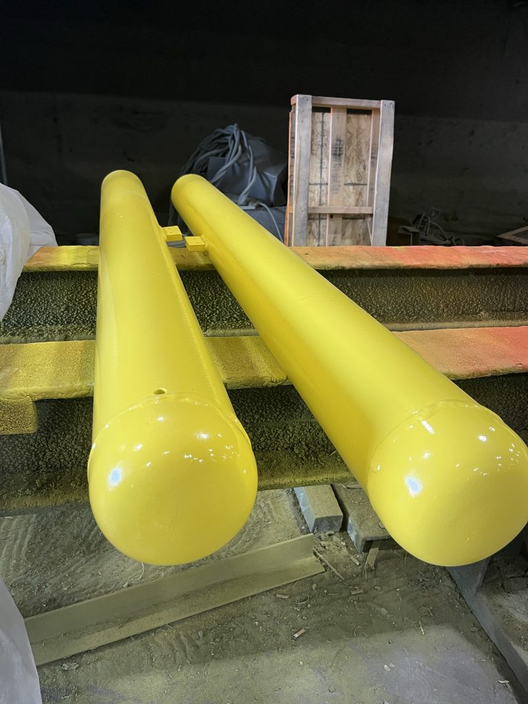 Two yellow painted metal pieces